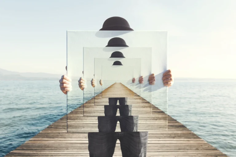 Man in a hat repeated in a mirror